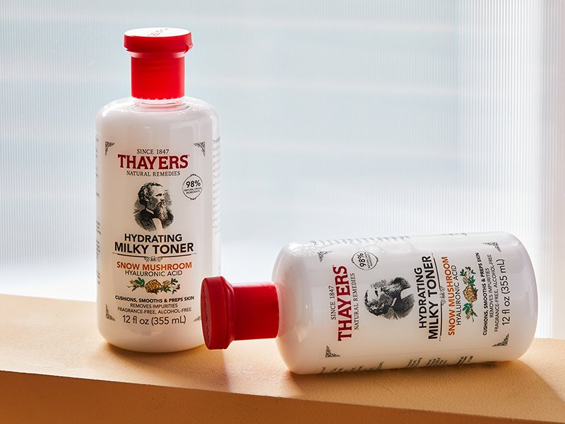 A picture of two bottles of the Thayers Milky Toner on a wooden beam