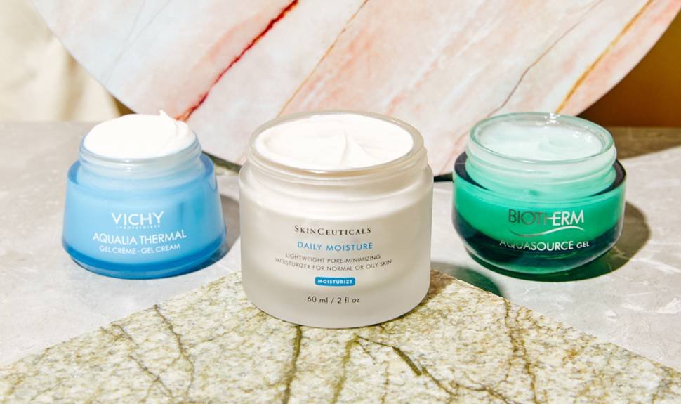 Three open containers of different skincare moisturizers
