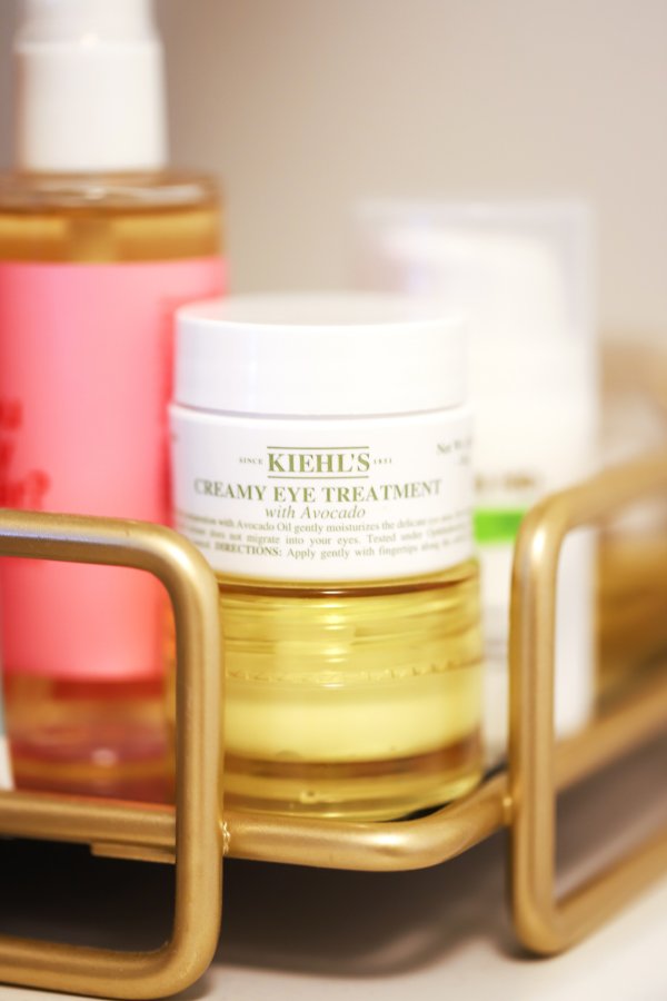 Bottle of Kiehl’s Creamy Eye Treatment with Avocado in a tray of beauty products