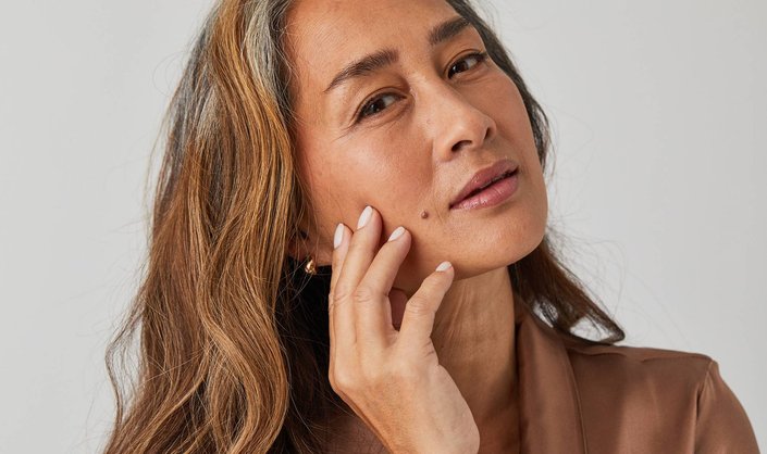 photo of person touching their face