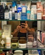 bathroom medicine cabinet filled with beauty products