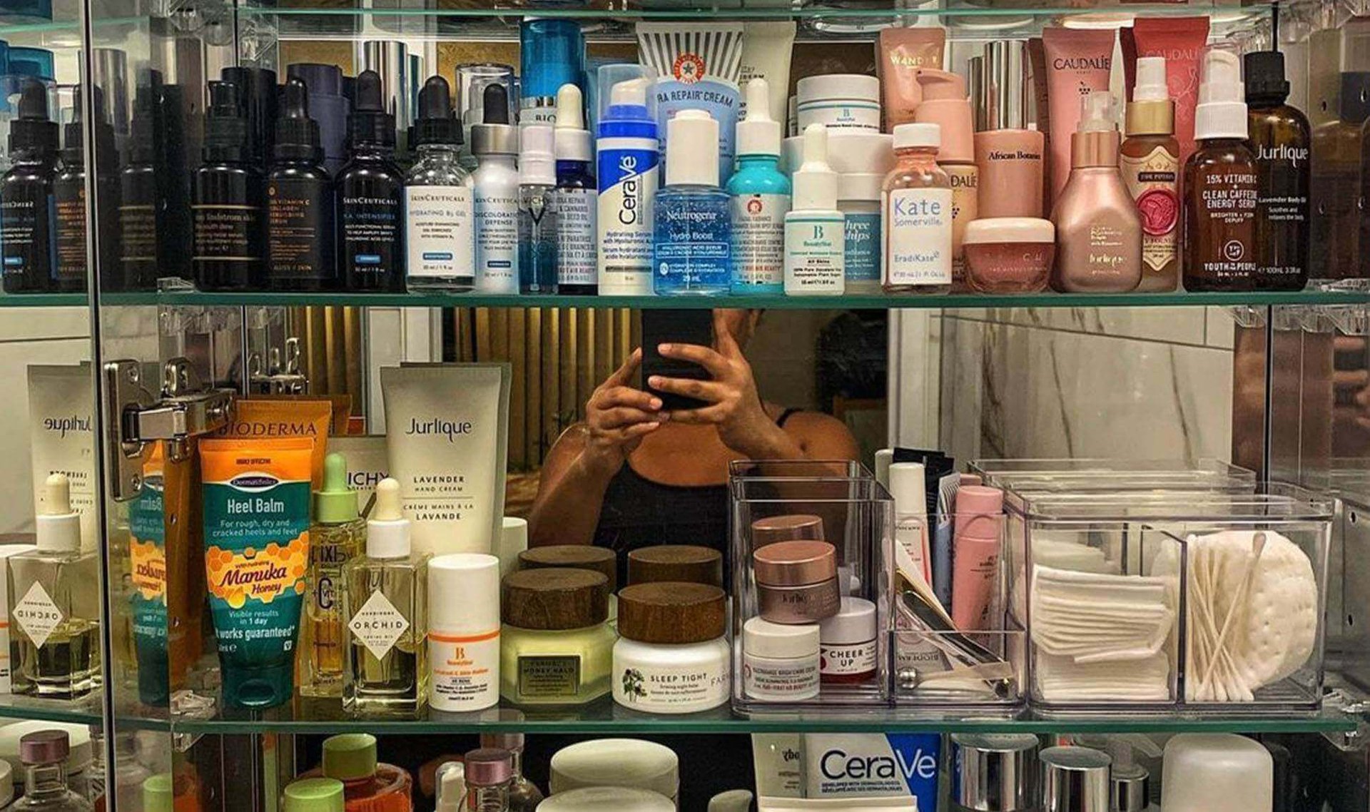 bathroom medicine cabinet filled with beauty products