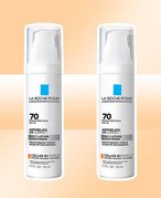 Two bottles of La Roche-Posay Anthelios UV Correct Face Sunscreen SPF 70 With Niacinamide on a graphic cream background