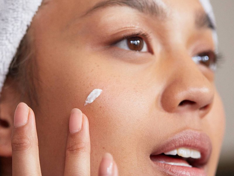 person applying face cream