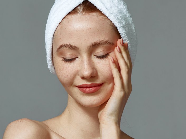 person posing with towel on head
