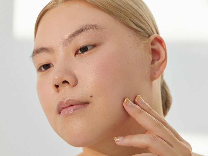 Person touching their jawline