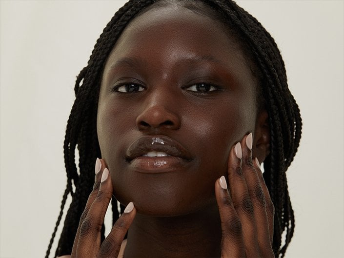 Person touching their cheeks and jawline