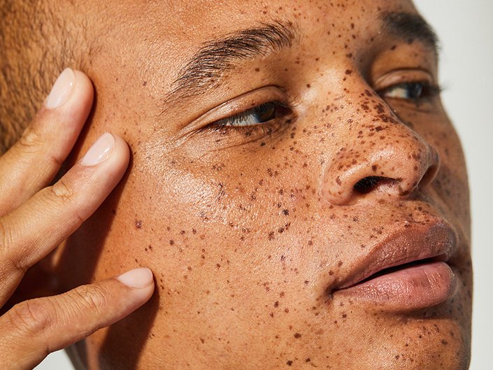 person touching their face