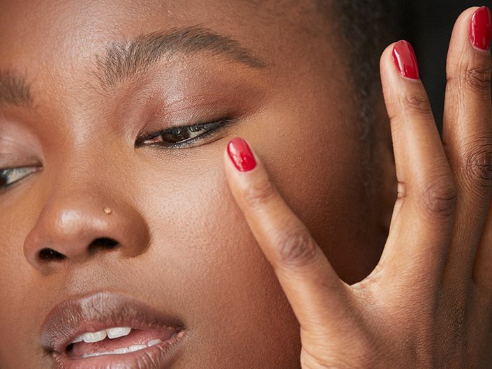 person touching under eye area
