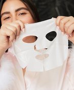 person holding sheet mask