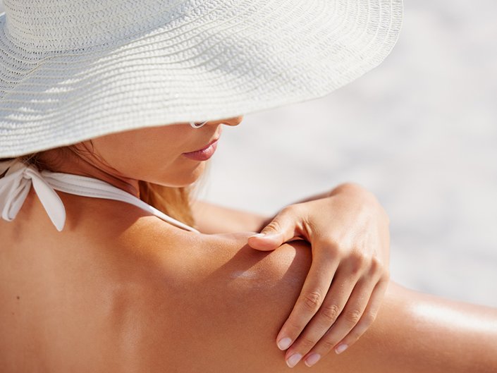 person massaging shoulder