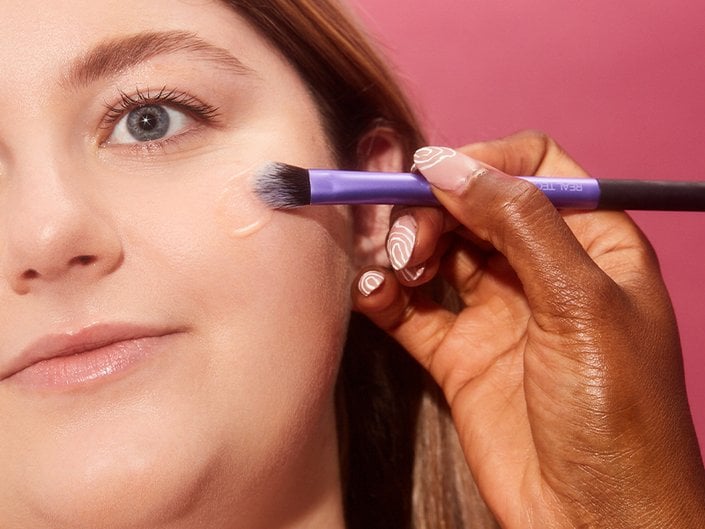 makeup artist applying makeup to a face