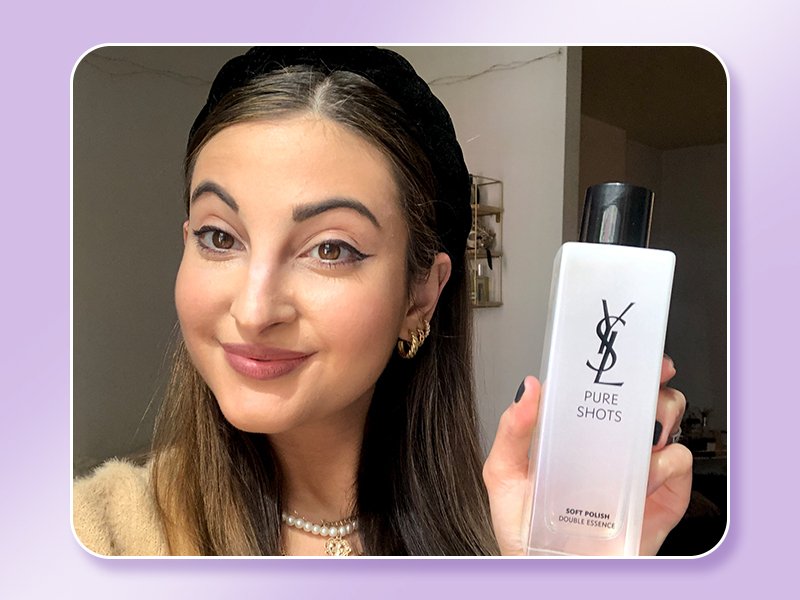 person holding ysl double bounce essence bottle
