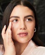 person touching their under-eye area