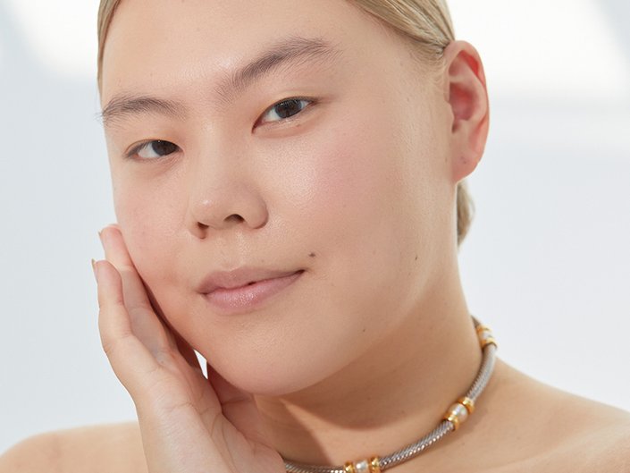 person posing with hand on face