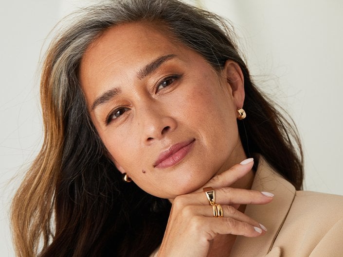Picture of a mature model looking at the camera and smiling softly