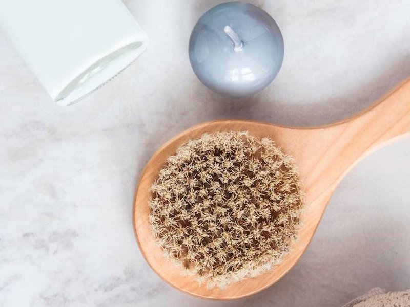 Image of a dry brush next to an unlit candle