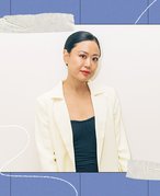woman in a white blazer on a blue framed background