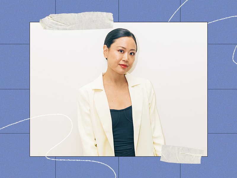 woman in a white blazer on a blue framed background