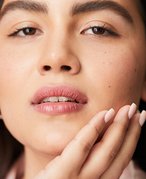Photo of a model touching the side of her face