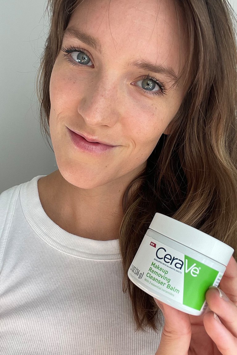 Editor with long dark hair holding up the CeraVe Makeup Removing Cleanser Balm