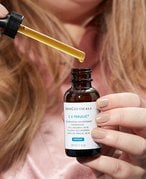Picture of a person’s hands holding the SkinCeuticals C E Ferulic with 15% L-Ascorbic Acid