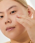 Picture of a model touching their under-eye area