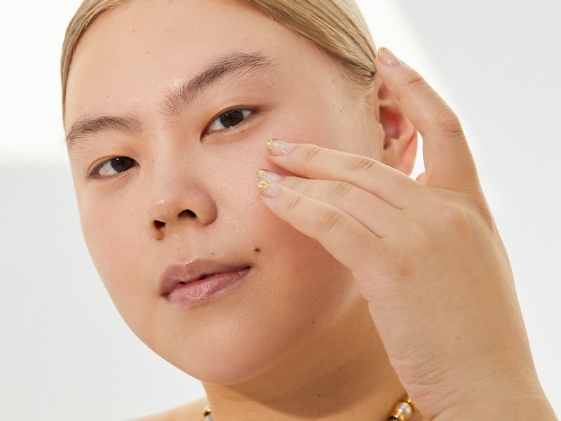 Picture of a model touching their under-eye area