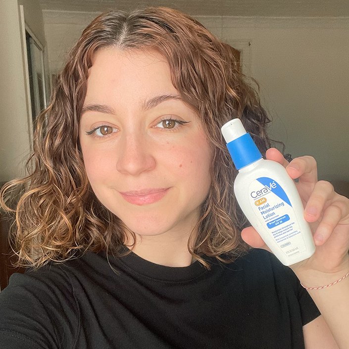 juliana posing with the CeraVe AM Facial Moisturizing Lotion with Sunscreen