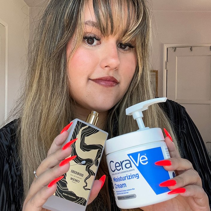 reece posing with the cerave moisturizing cream and memo paris perfume