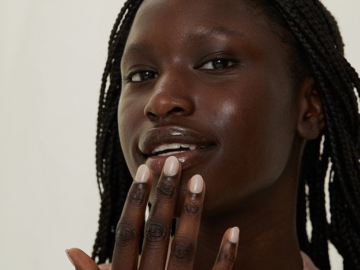 Person touching their fingers to their lips