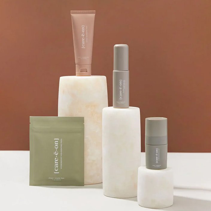 care e on skincare products photographed on a terracotta background