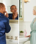 A picture of a male model and a female model looking in the mirror