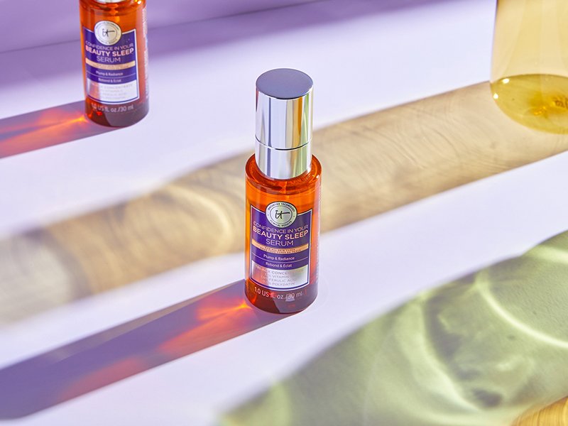 Two bottles of the IT Cosmetics Confidence in Your Beauty Sleep Serum on a table top.
