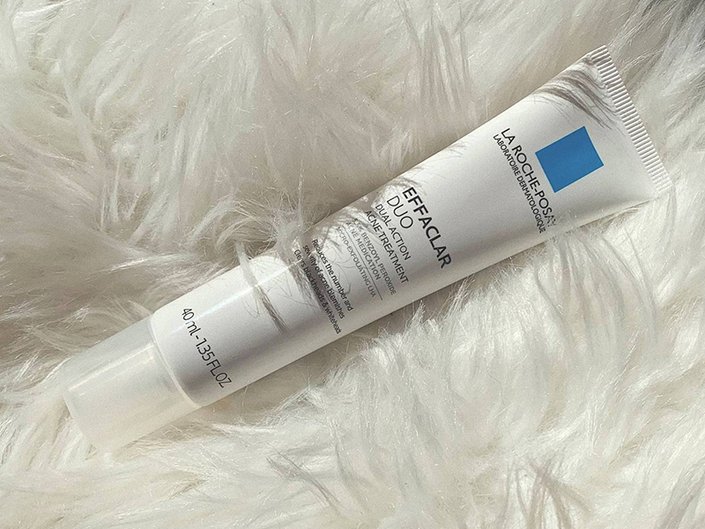 La Roche-Posay Effaclar Duo Acne Spot Treatment on top of a white fuzzy blanket