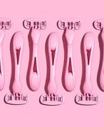 Picture of seven pink razors on a matching pink background