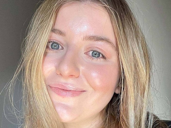 Selfie of an editor with long blonde hair and a shiny layer of CeraVe Healing Ointment on her skin