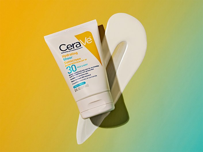 Tube of the CeraVe Hydrating Sheer Sunscreen for Face and Body and swatch of the formula on a yellow and green ombré background