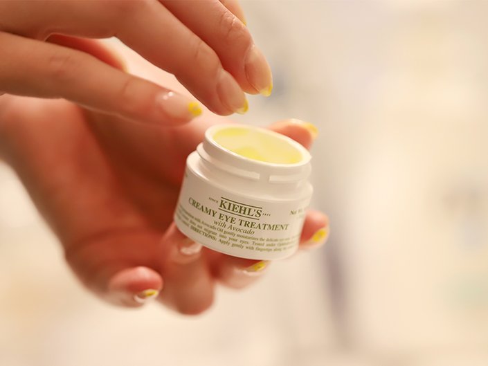 Close-up of hands holding the Kiehl’s Creamy Eye Treatment With Avocado