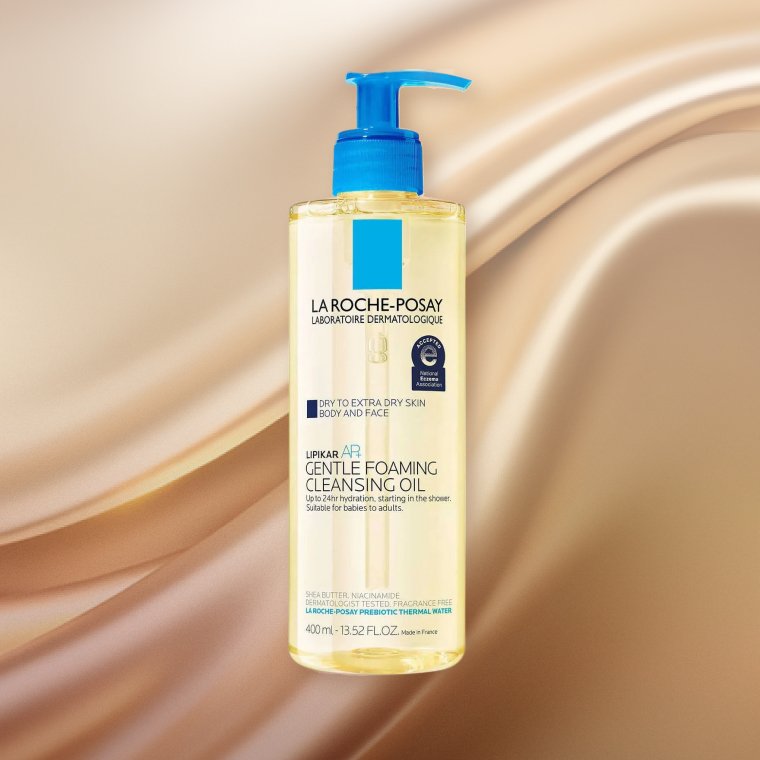 Bottle of La Roche-Posay Lipikar AP+ Gentle Foaming Cleansing Oil on a textured background