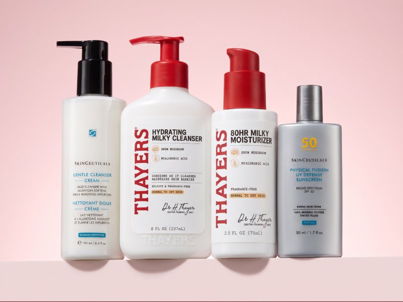 Three minimalist skincare products— SkinCeuticals Gentle Cleanser, Thayers Milky Moisturizer, and SkinCeuticals Physical Fusion UV Defense SPF 50—arranged on a soft gradient background, embodying a stripped-back skincare reset routine.