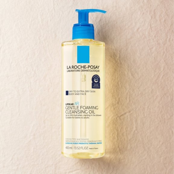 The Lipikar AP+ Gentle Foaming Cleansing Oil against a white or neutral, textured background
