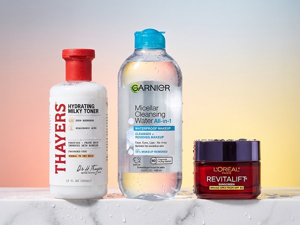 Key skincare products for different climates—cleanser, moisturizer, and sunscreen—arranged on colored backgrounds with water droplets and botanical ingredients, no people present.