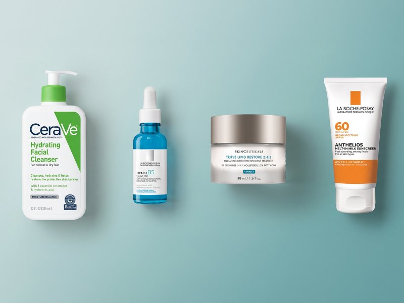 Flat lay of gentle facial cleanser, hydrating serum, ceramide-rich moisturizer, and sunscreen on a clean, neutral background, illustrating a simple skin barrier routine.