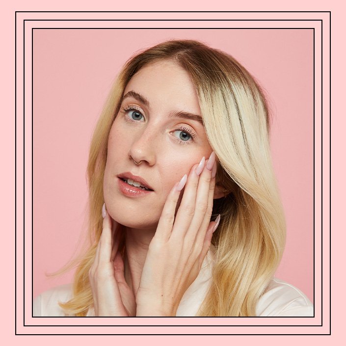 person with their hands on their cheeks