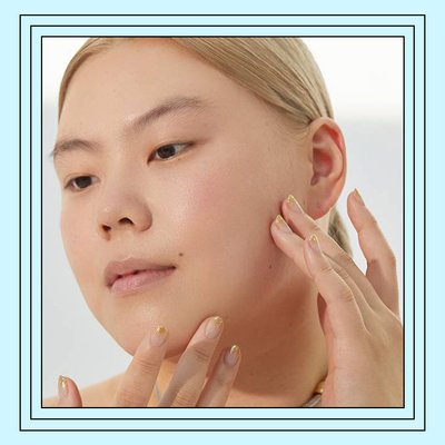 Close-up of model touching their face